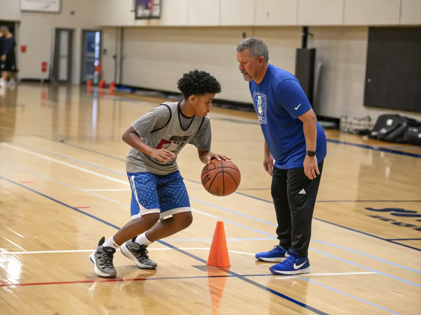A photograph of a NAVES BASKET CLUB coach providing personalized instruction to a player during a one-on-one training session, emphasizing technique and skill refinement.